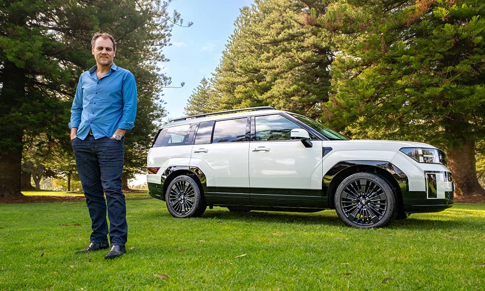 Alex Forrest posing with a 2024 Hyundai Santa Fe