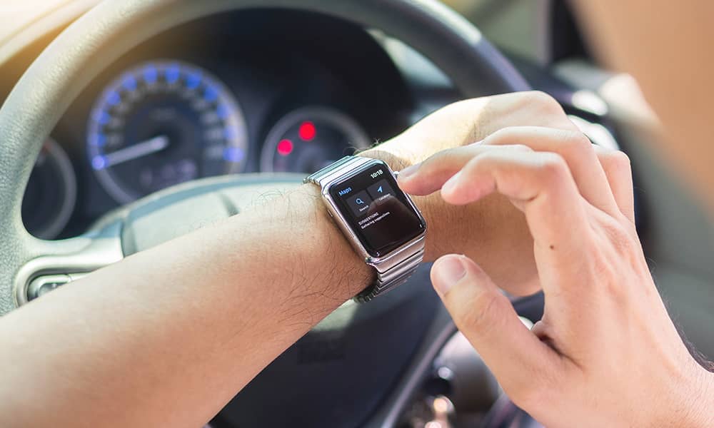 Image of someone checking their watch while driving