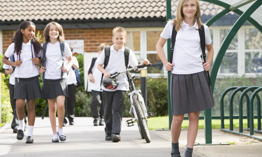 School students standing near the bike rack on campus