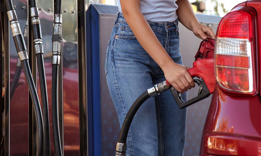 Woman putting fuel in her car
