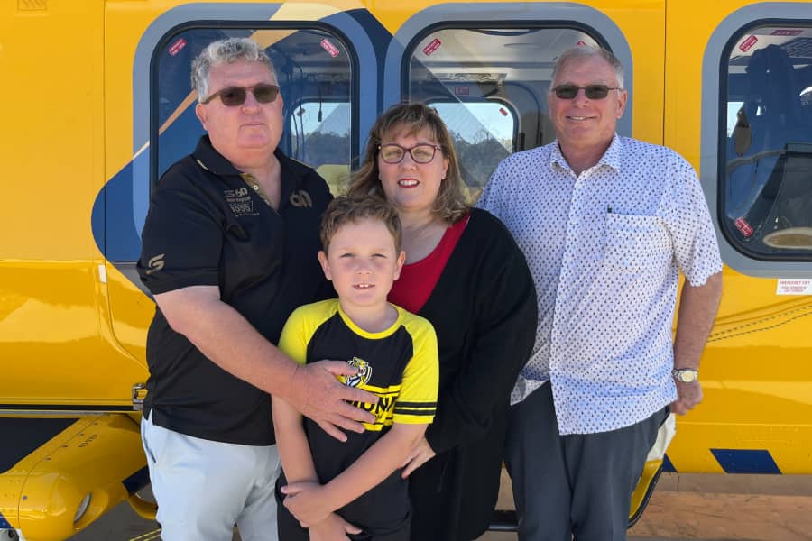 Kelly and family in front of RAC Rescue helicopter