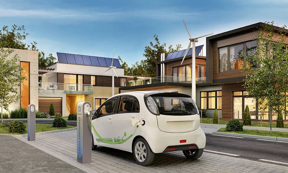 Image of an electric car charging outside of a home