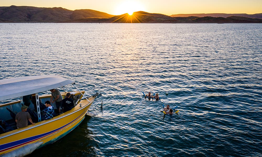 People swimming near boat