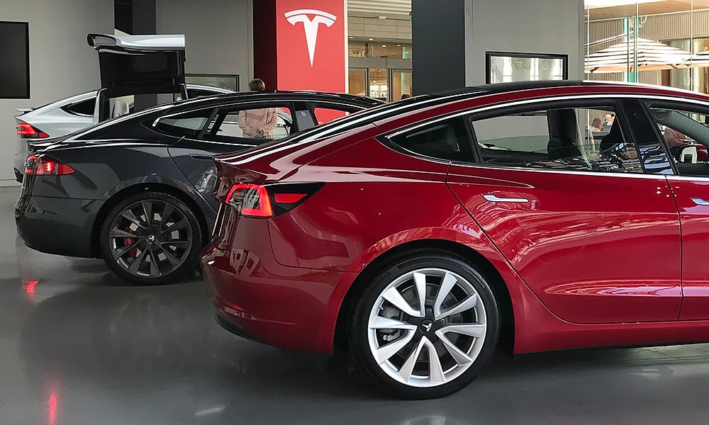 Three Tesla cars in a Tesla showroom
