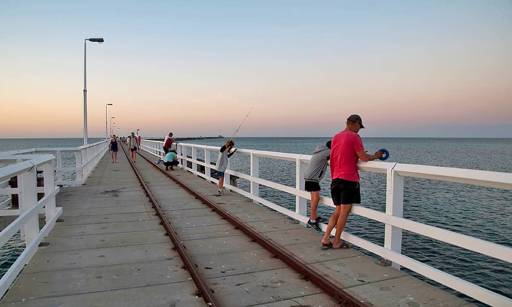 A father and son fishing from Busselton Jetty