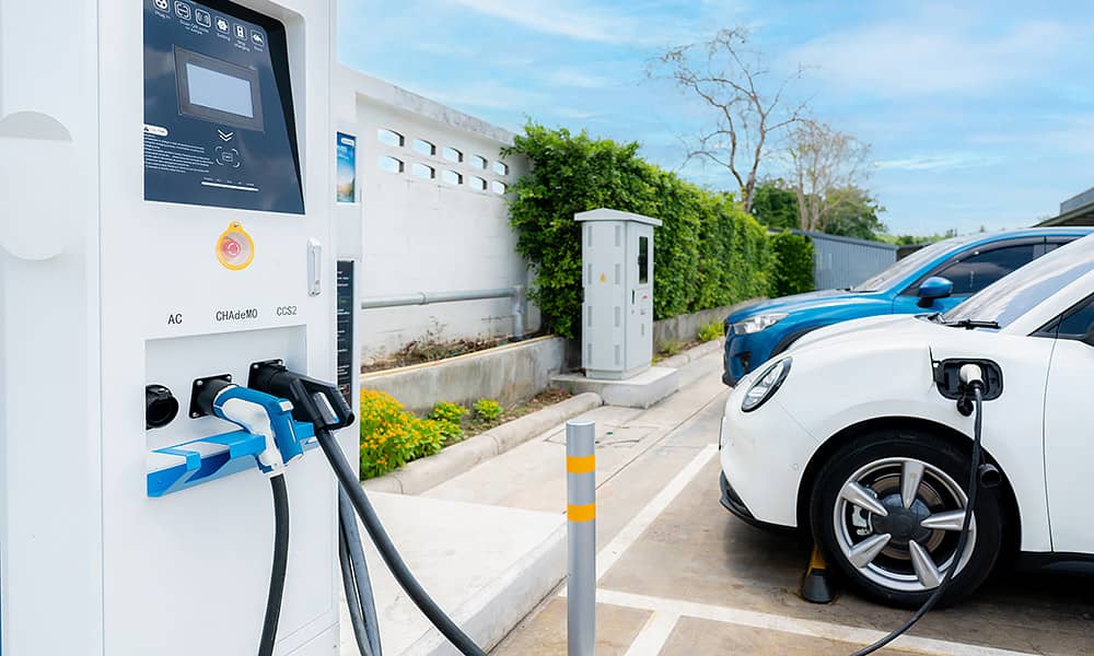 Two EVs charging at a public EV charging station