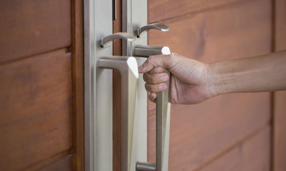 A man opening a front door