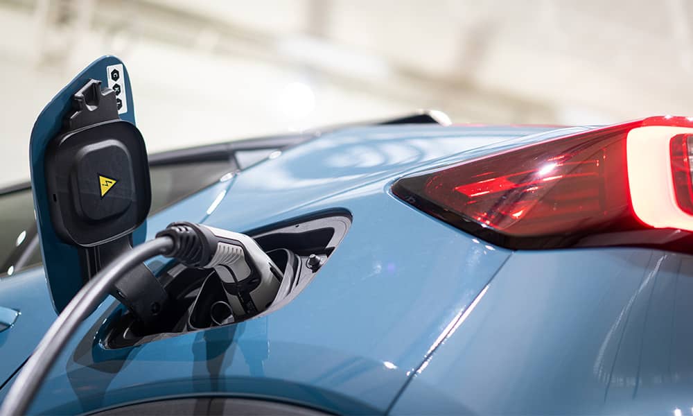 An electric car with its charger plugged in