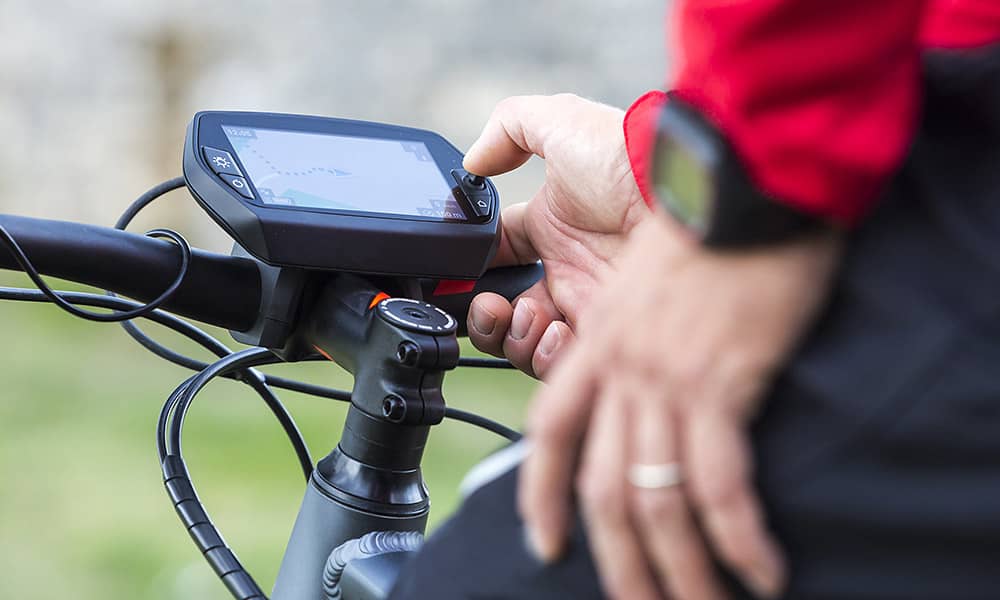 Man adjusting controls on an ebike screen