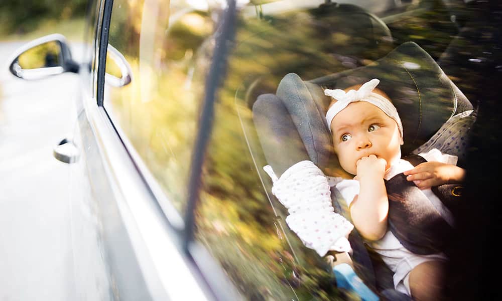 Small child looking out of a car window
