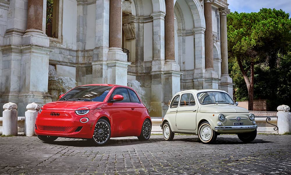 Fiat 500e parked alongside the original Fiat 500