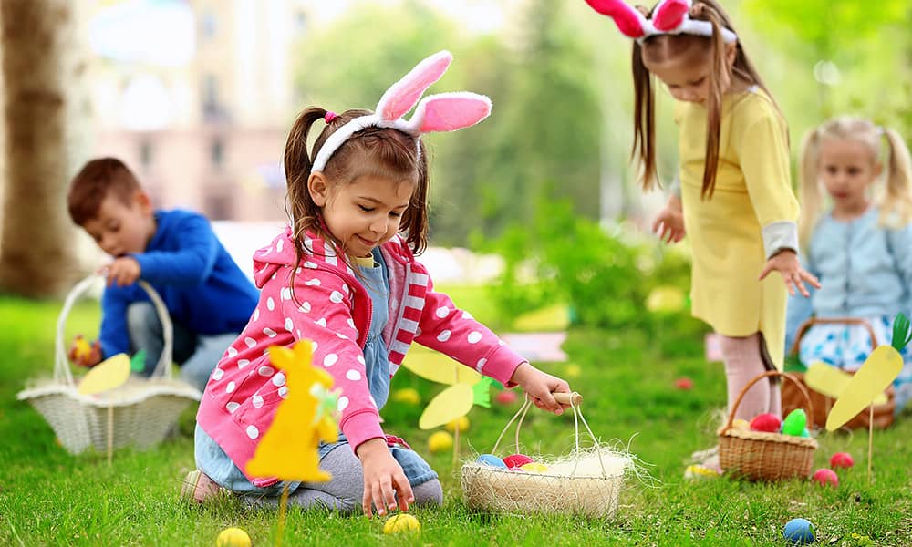 Children collecting Easter eggs in baskets