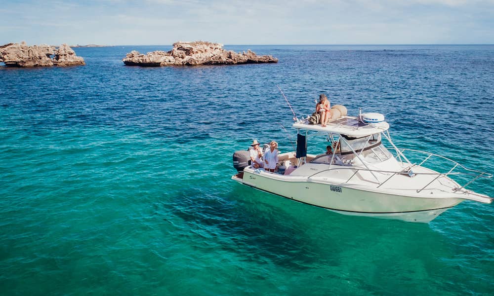 People fishing off boat near islands
