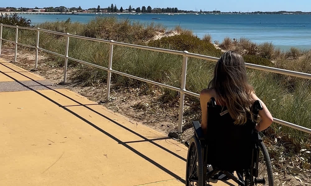 A woman on a wheelchair visiting an outdoor trail
