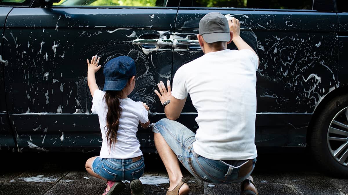 Image of family washing car