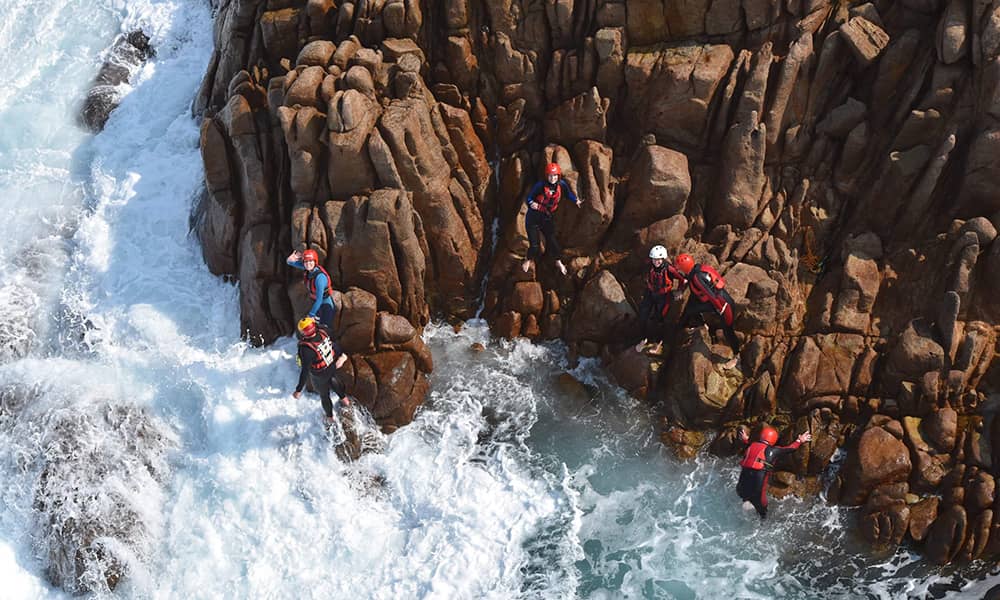 People jumping off coastline