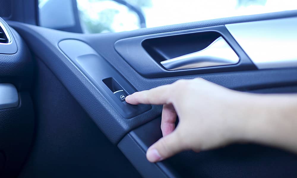 Hand on a car door lock