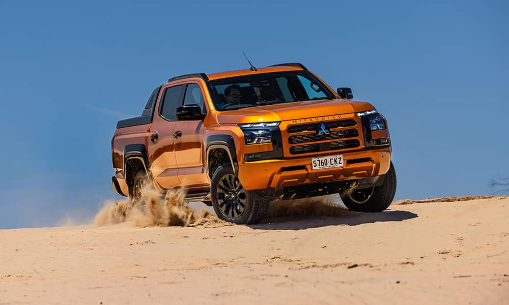 2024 Mitsubishi Triton driving on sand