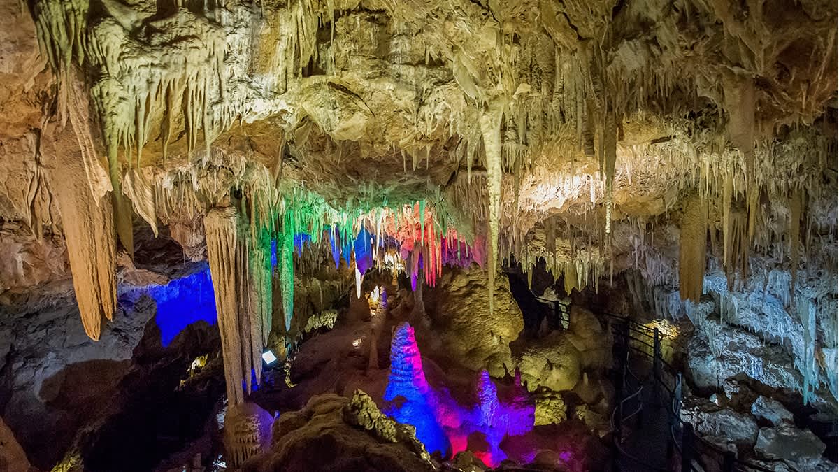 Caves lit up with colourful lights.