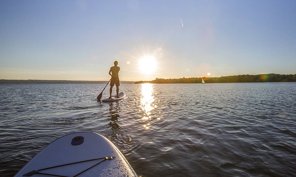 Stand-up paddle boarding at sunset