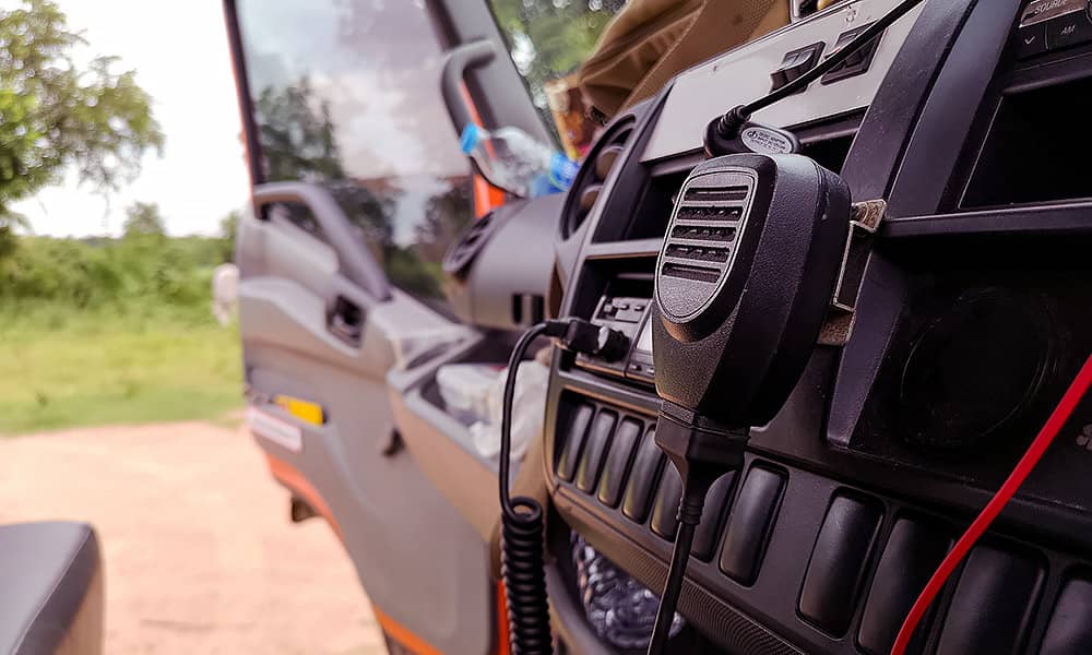 A close-up of car interior with a UHF radio in the dashboard