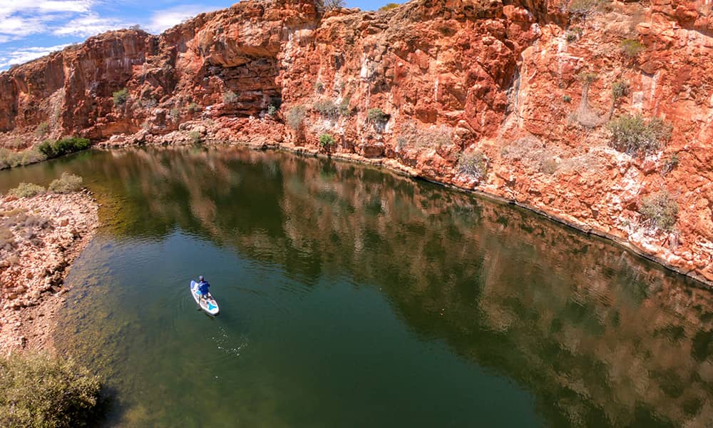 Man paddling down creek
