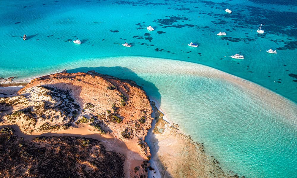 Aerial view of Coral Bay beach with boats in water
