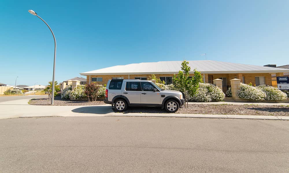 Car parked outside suburban house