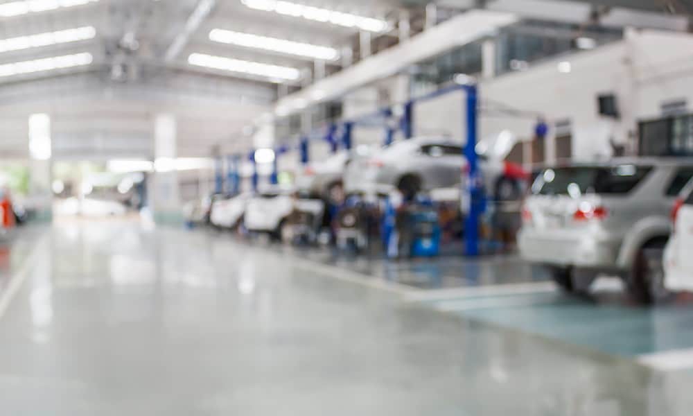 Cars being serviced in a large workshop