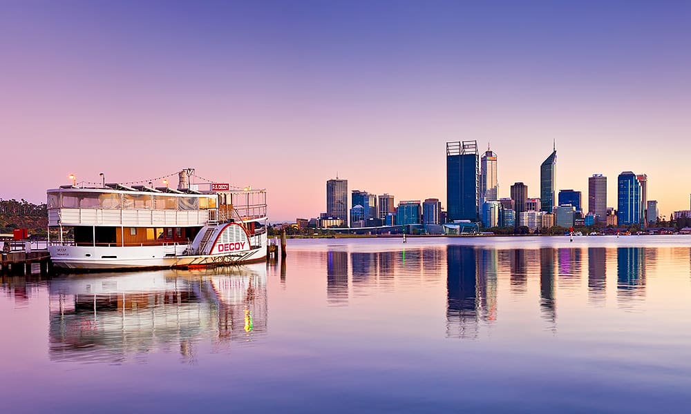 Perth City skyline at sunset from South Perth foreshore with a paddle steamer to the left of frame