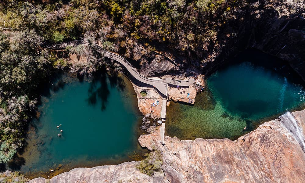 Aerial shot of a waterfall and pool
