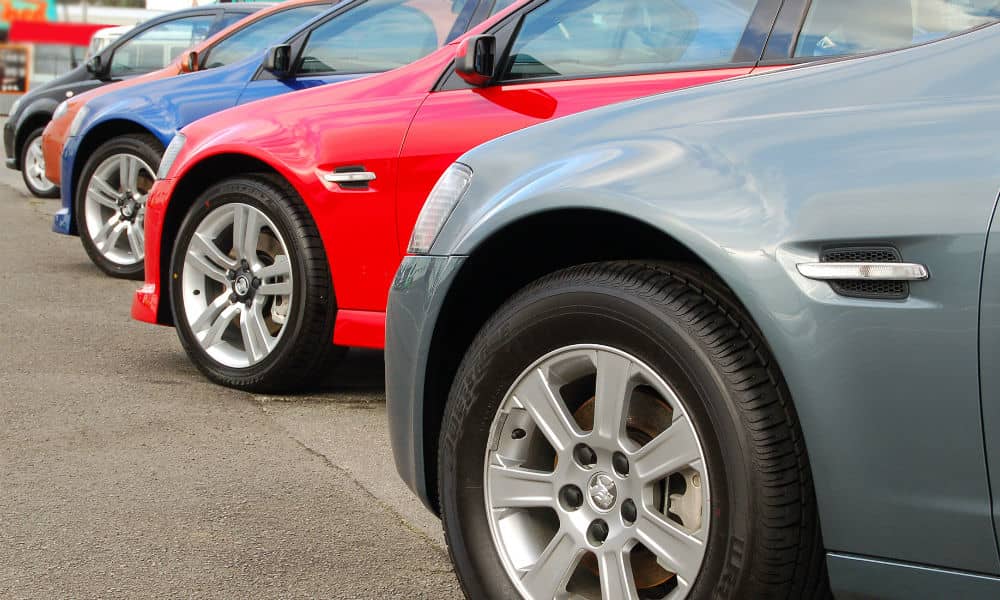 A row of new cars at a dealership