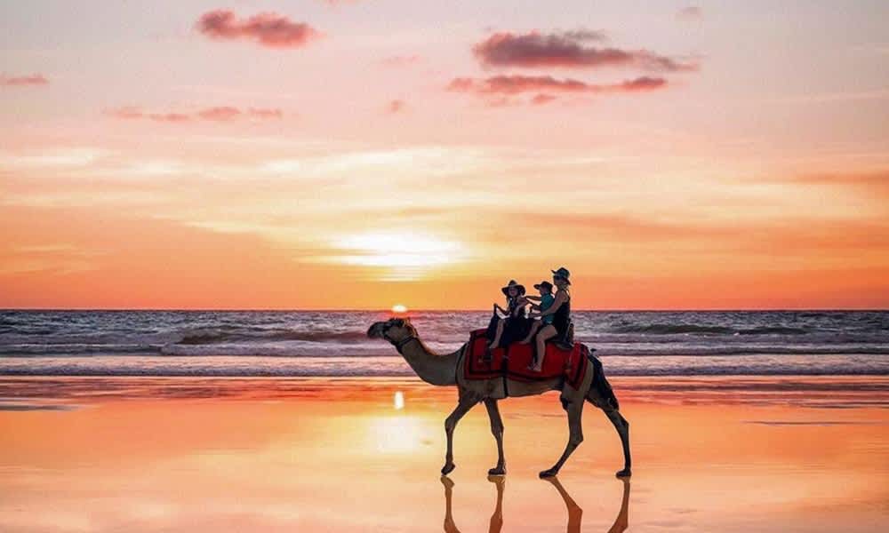 Family enjoying sunset camel ride at Cable Beach Broome