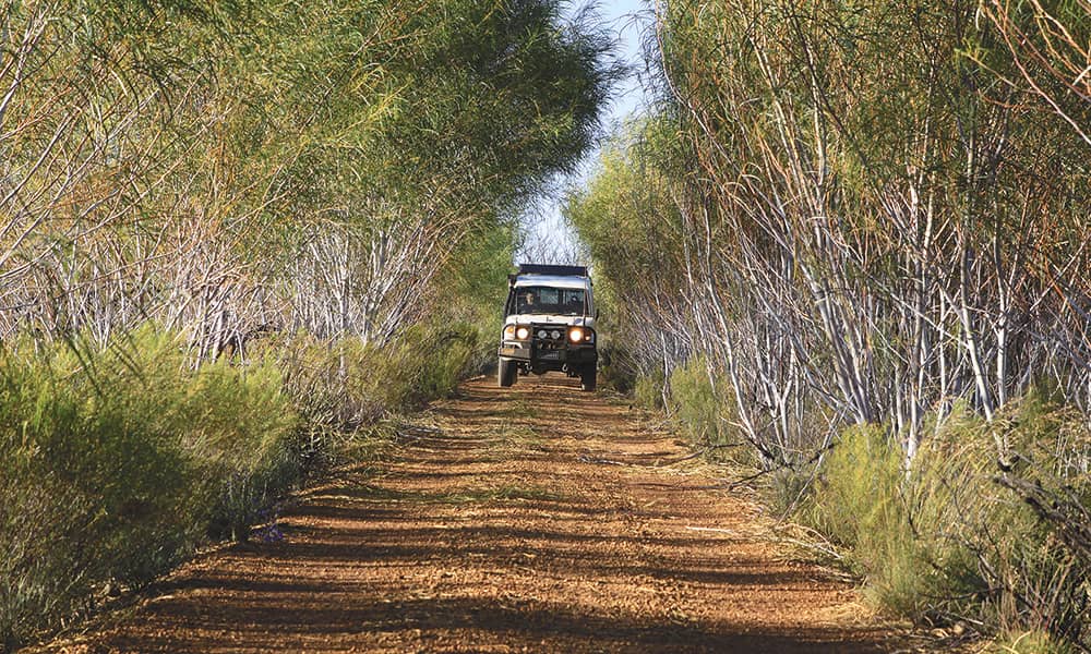 Car driving down a dirt track