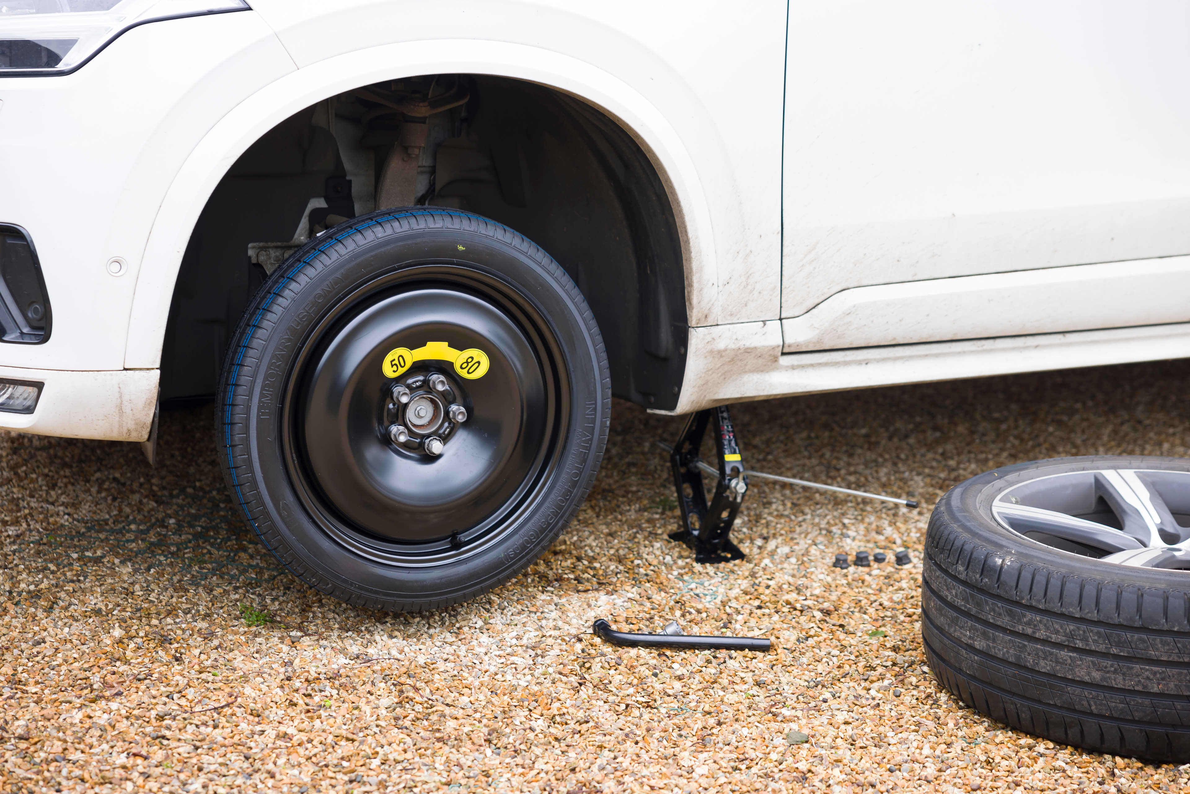 A space saver tyre has been fitted to a car which is jacked up