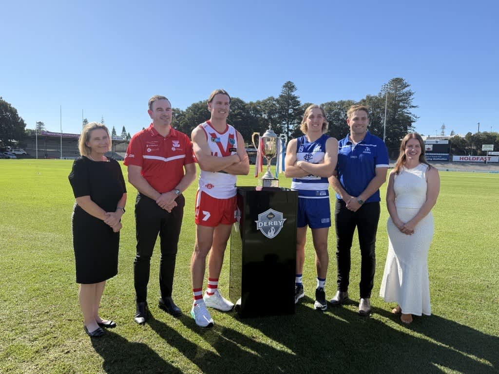 People posing with a trophy for the RAC Derby