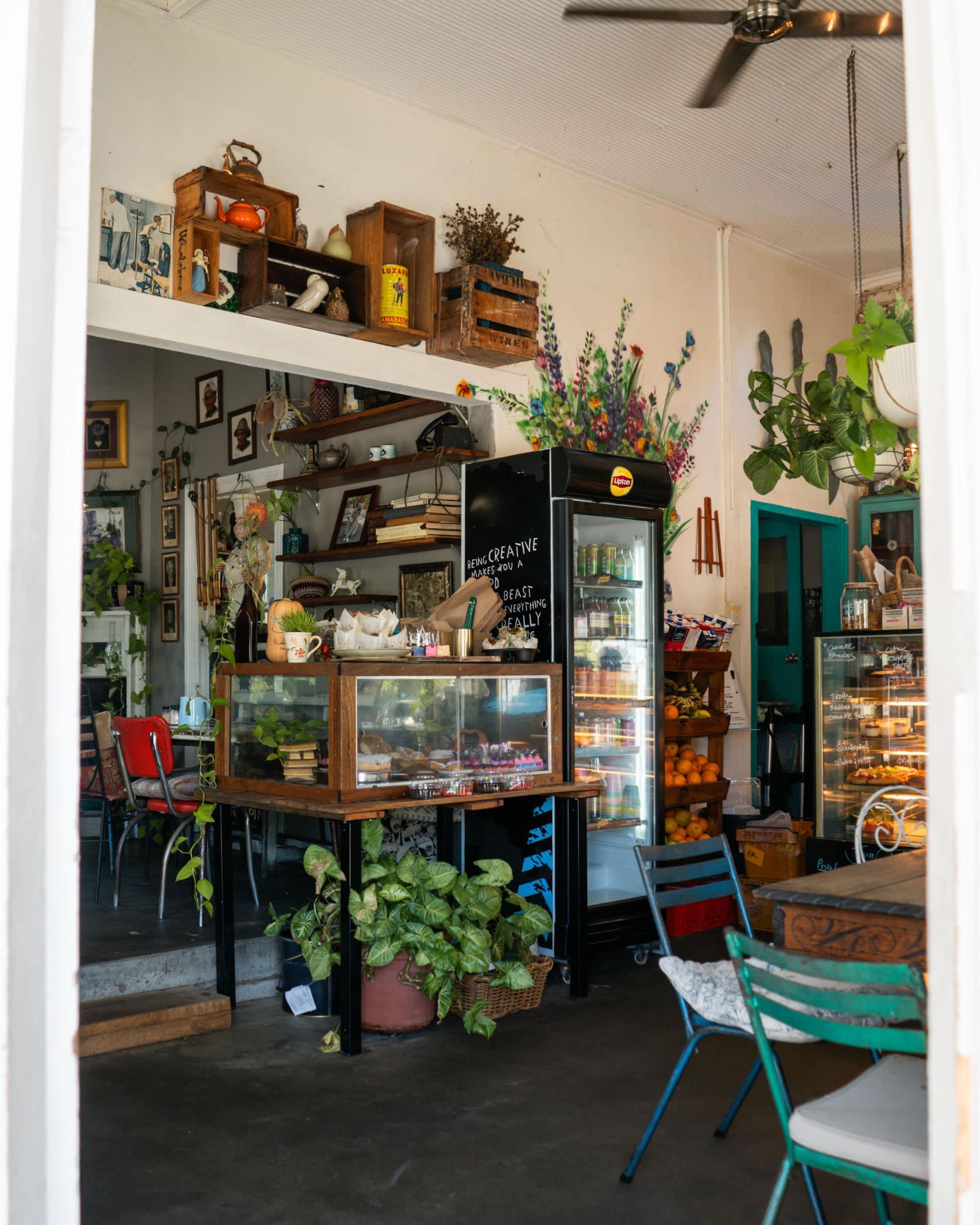 Interior of cosy cafe with vintage furniture and indoor plants.