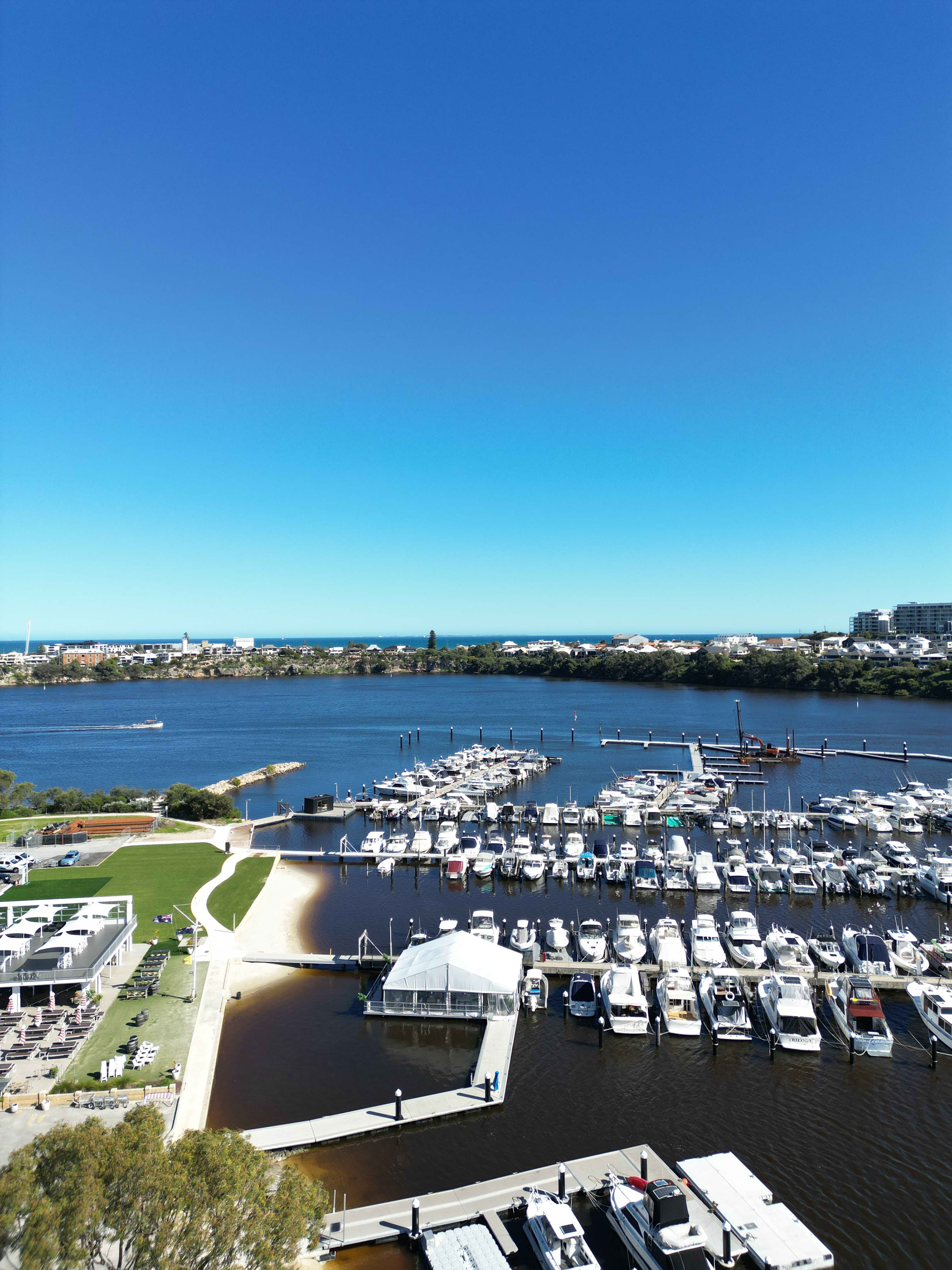 Swan Yacht Club and dozens of moored boats on Swan River