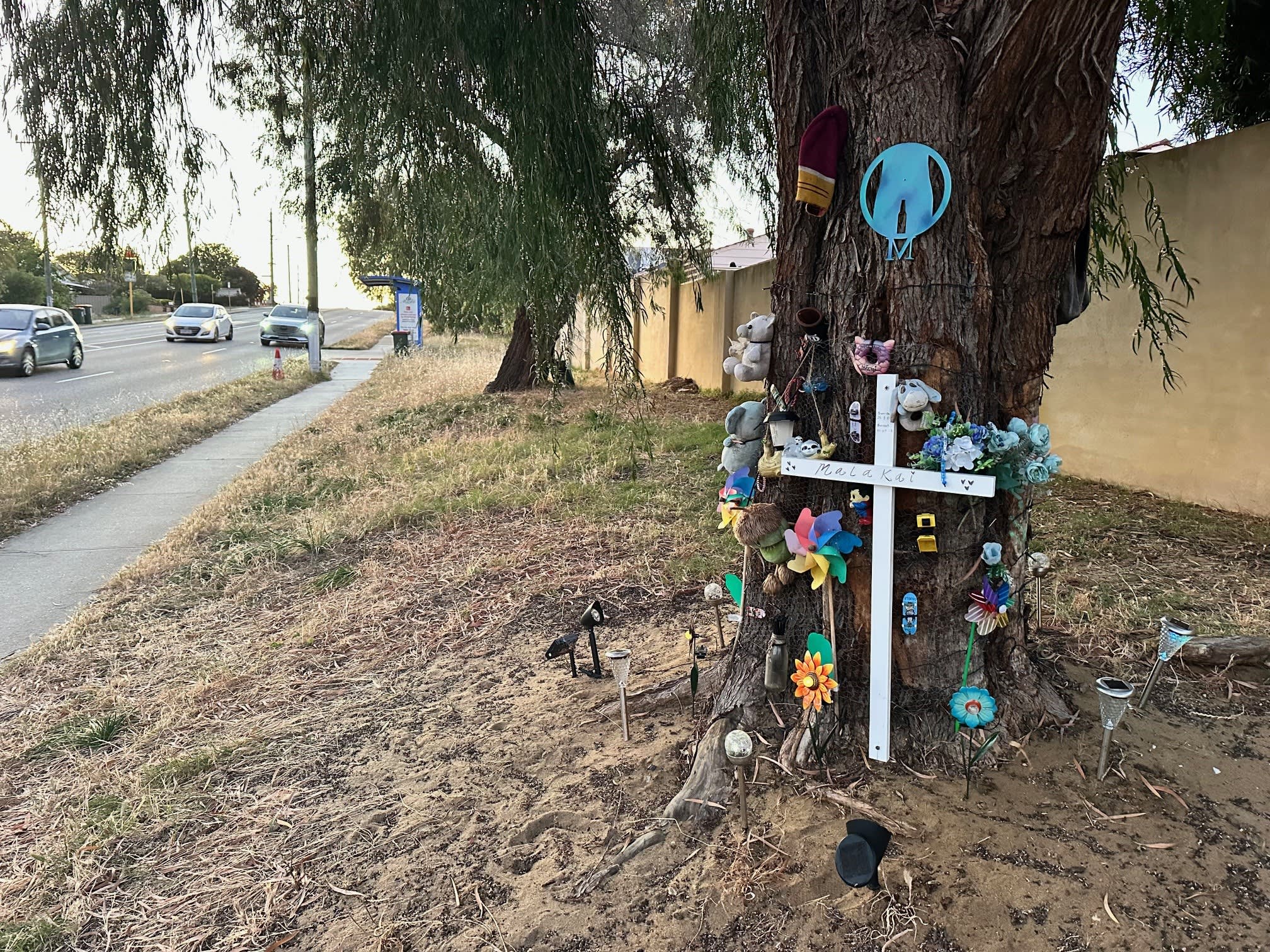 Roadside cross with flowers and stuffed animals