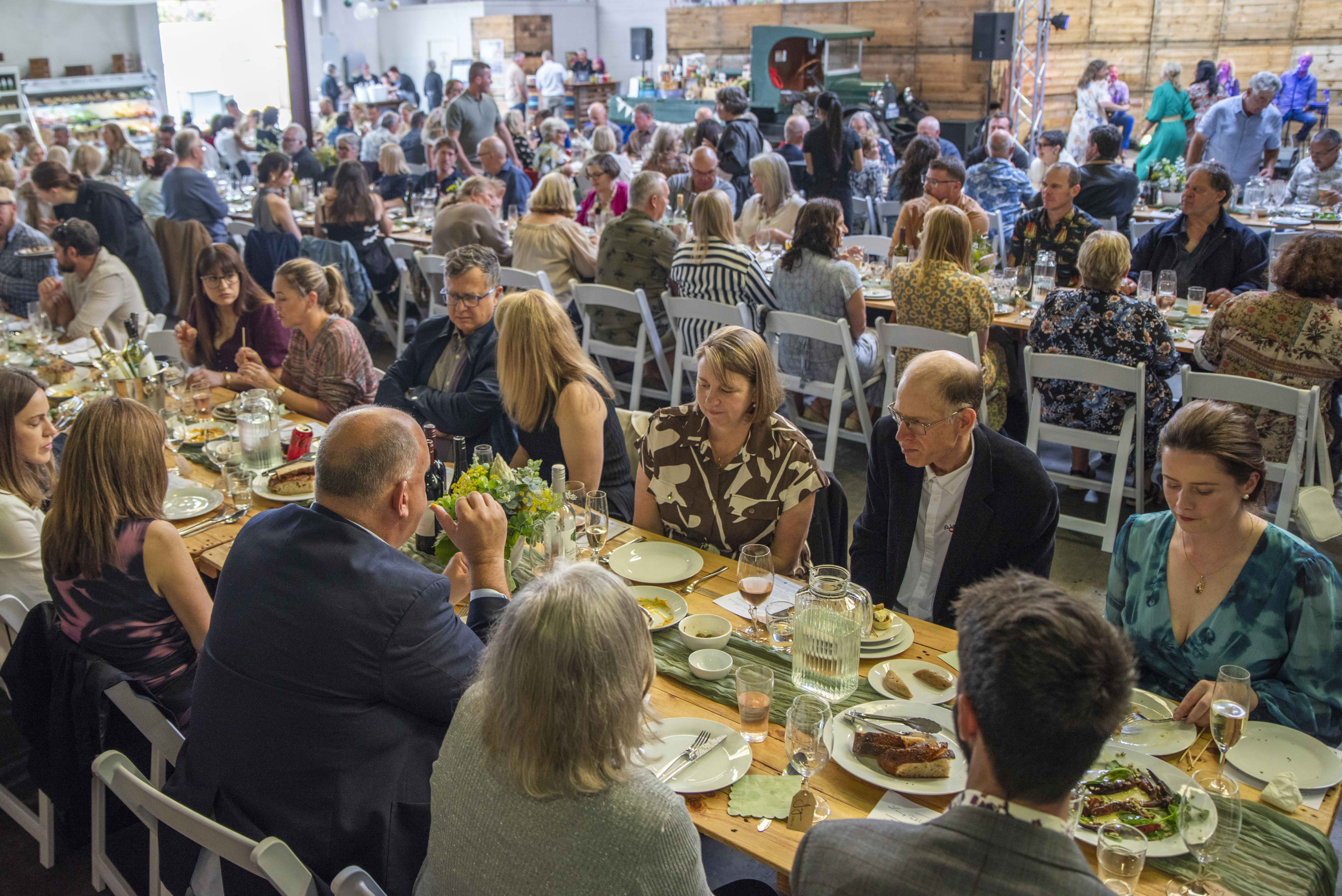 People seated at long tables sharing food