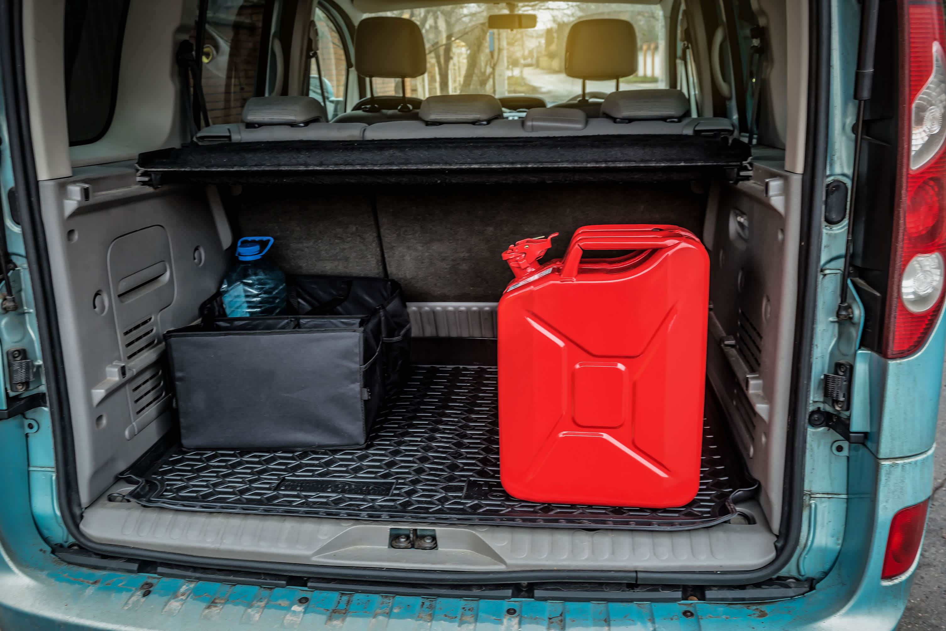 A red fuel canister in the rear of a van.