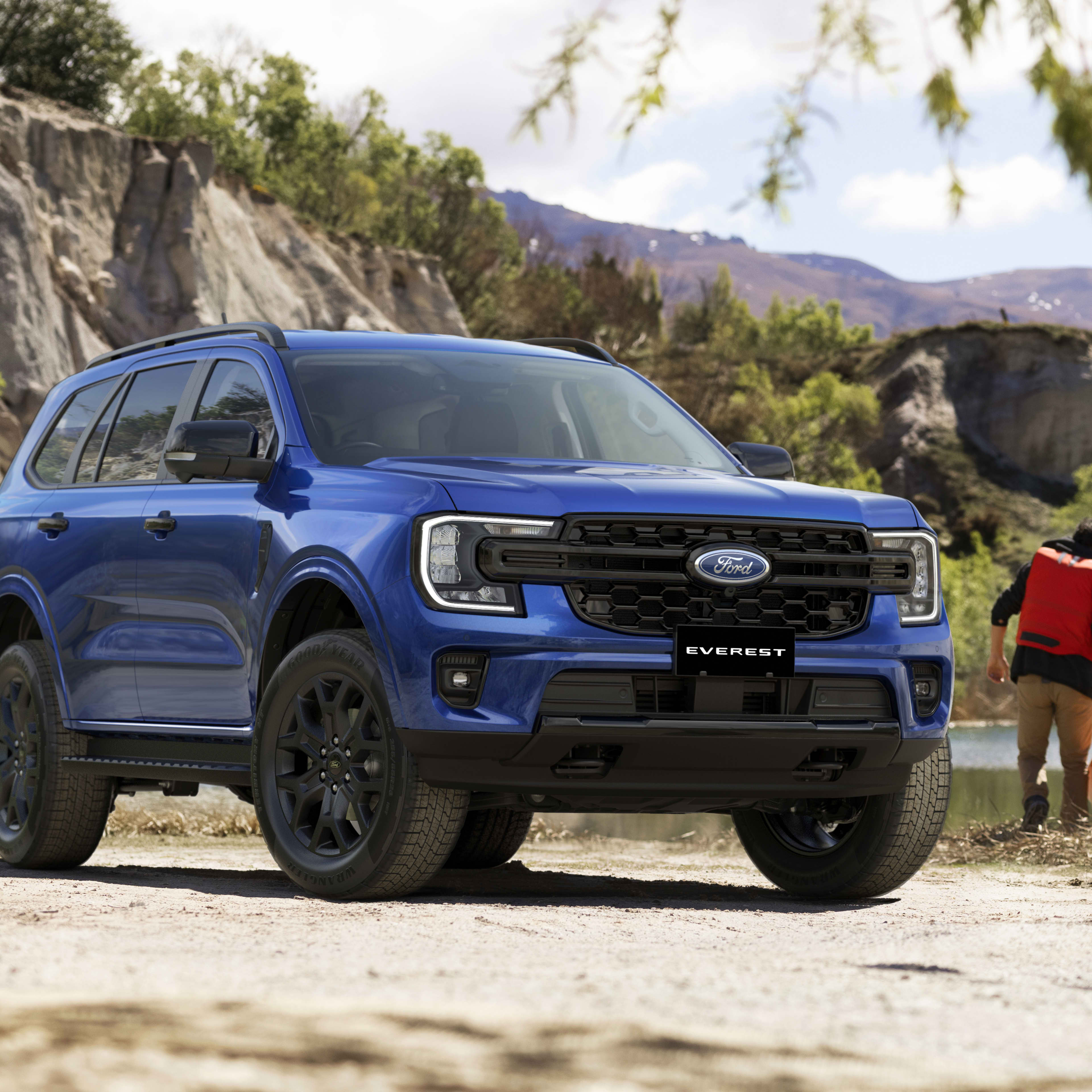 A blue Ford Everest in a mountainous landscape.
