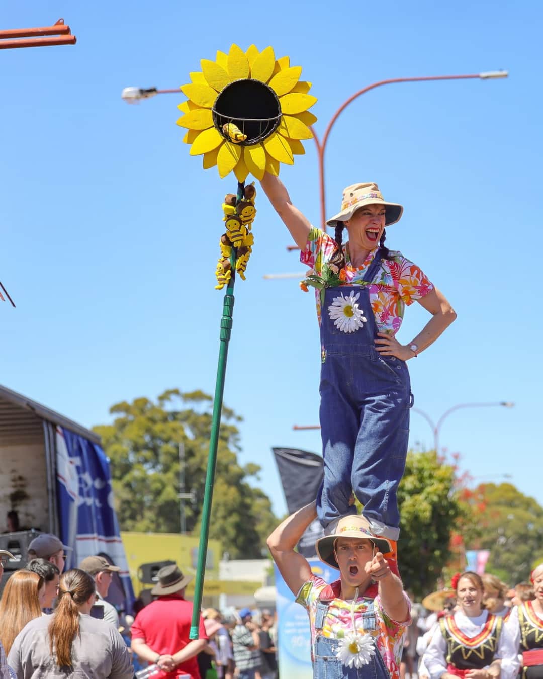 Street performers in overalls on a street parade