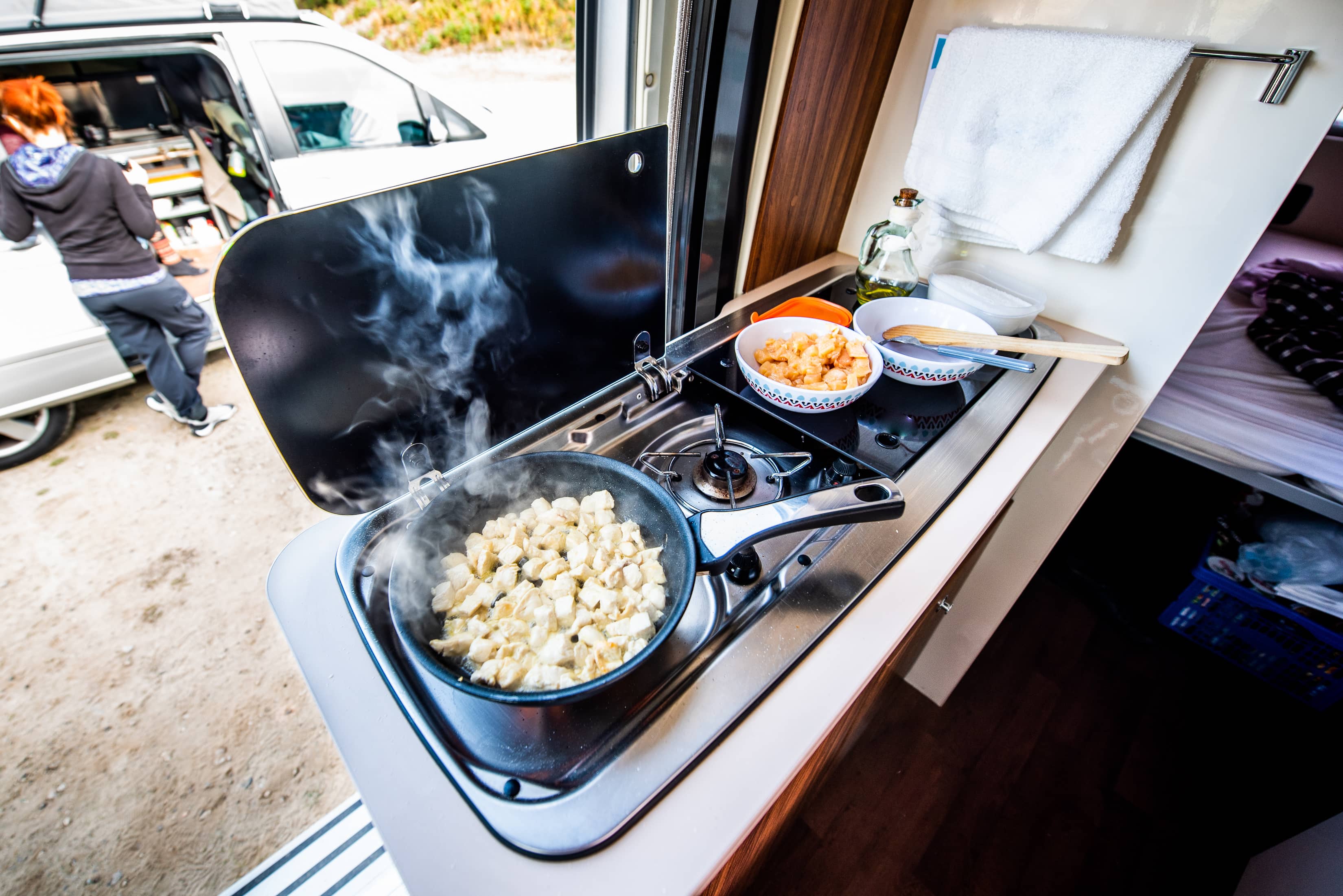 Food cooking on a stove in a caravan