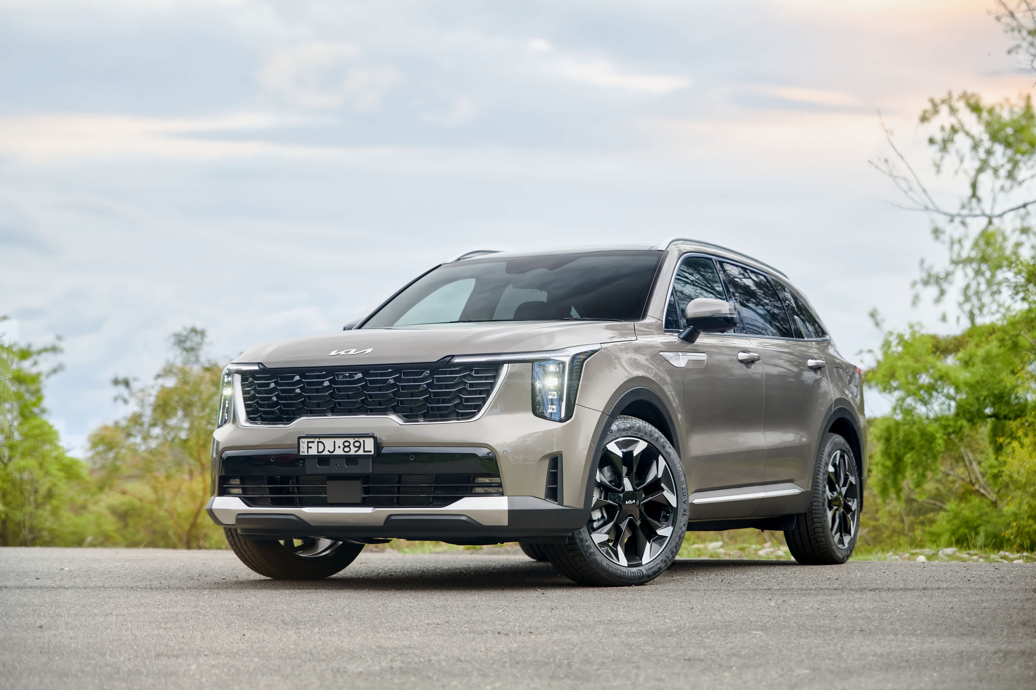 A light brown Kia Sorrento Hybrid parked