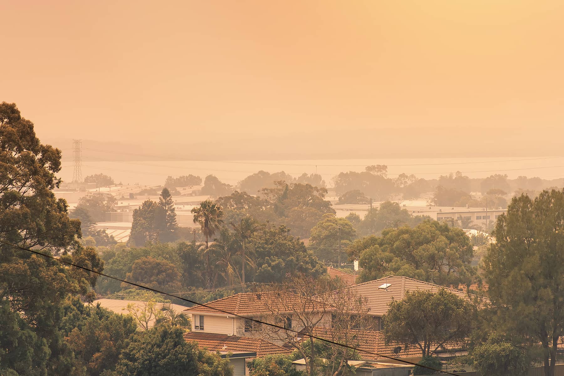 A smoke-filled outlook over suburban homes