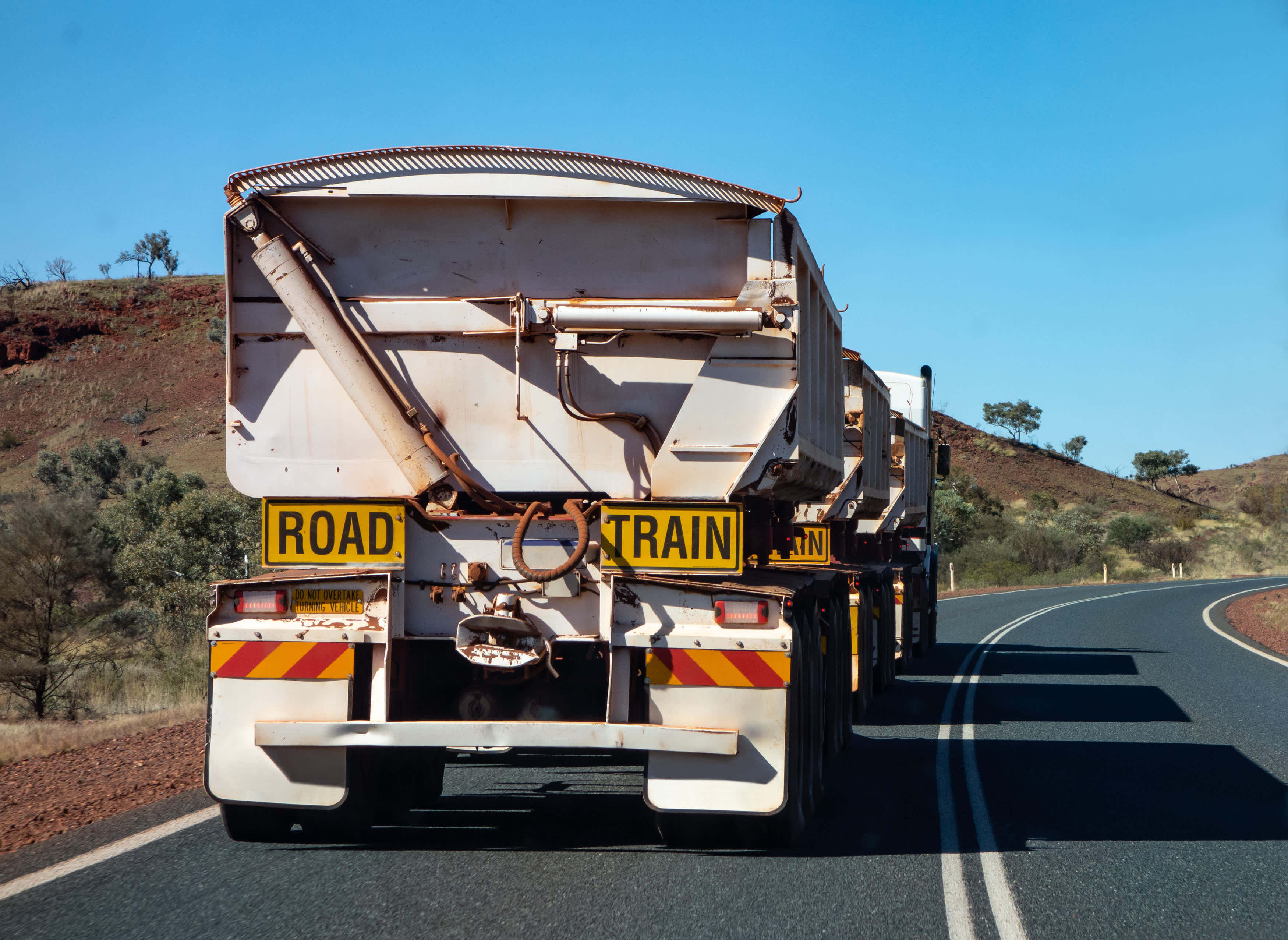 A road train on a regional WA road seen from the rear