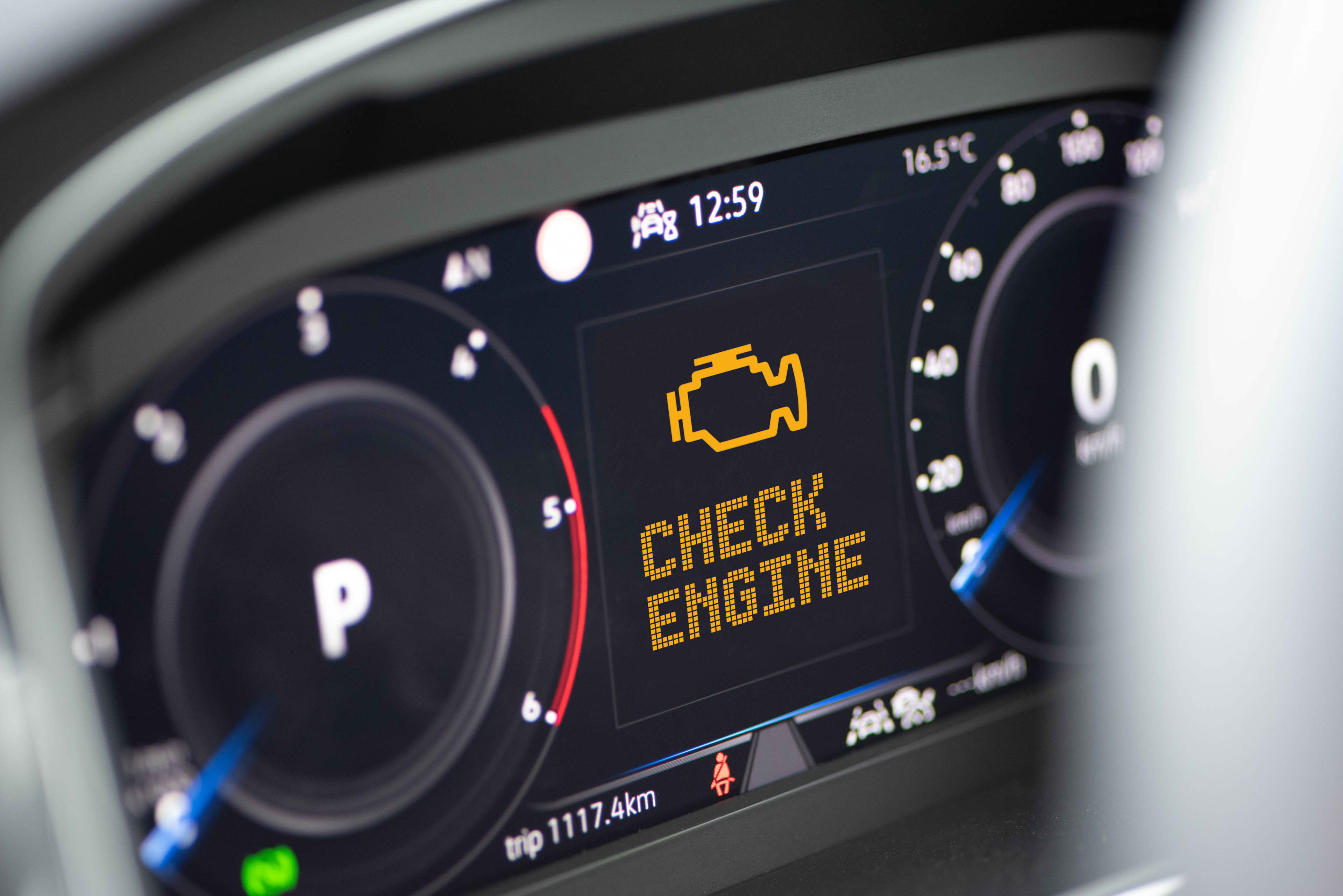 A close up of a car dashboard with a Check Engine Light displayed