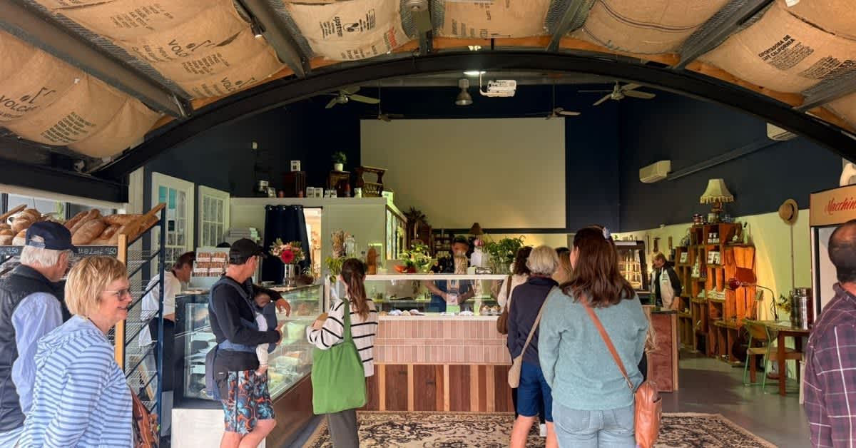 People milling around the cafe bakery shop browsing.