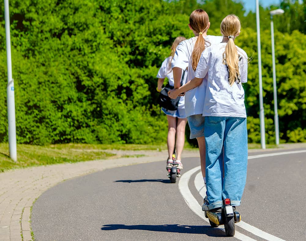 Children riding escooters without helmets